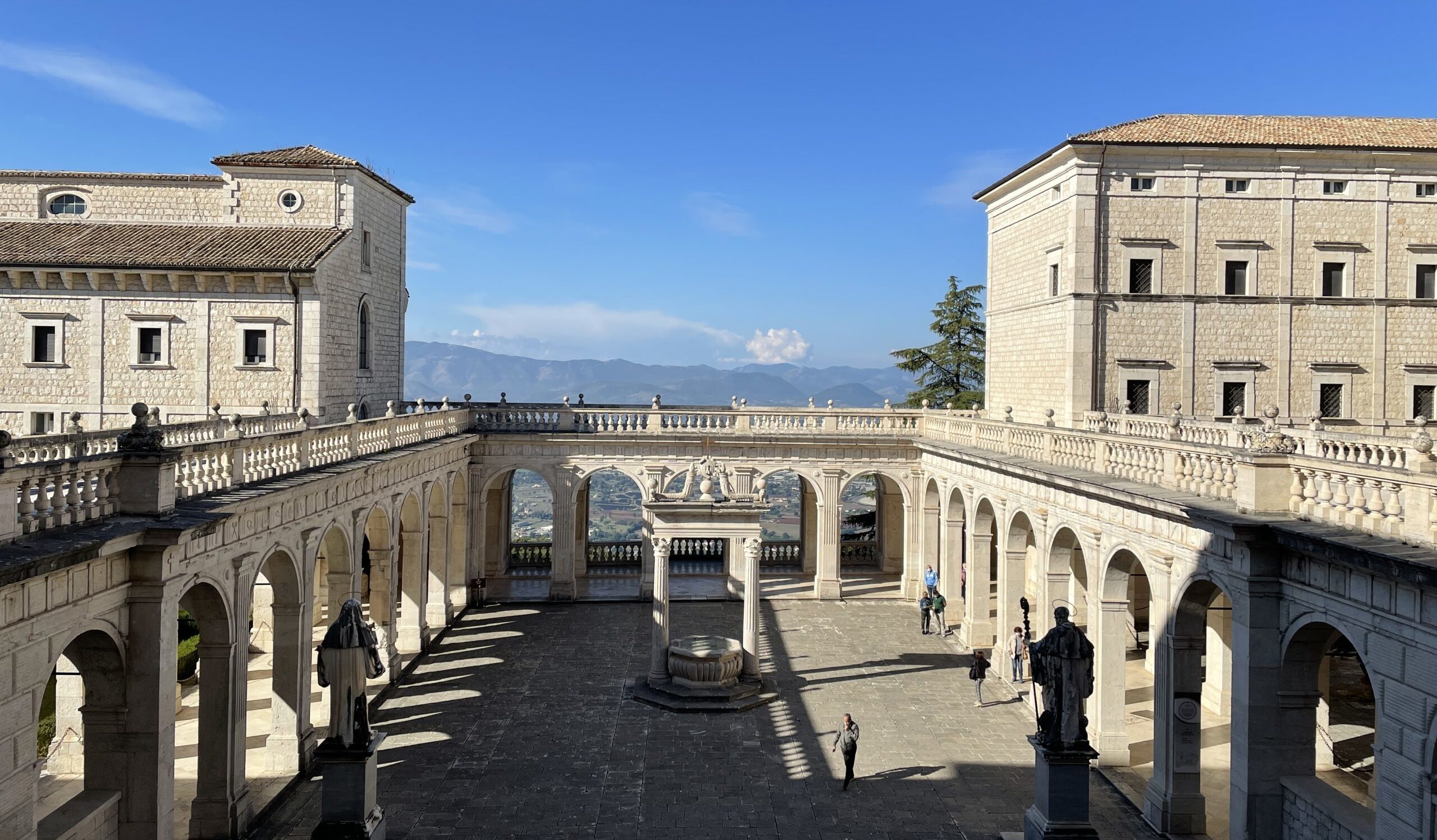 Picture of a courtyard from above. On the background a blue sky